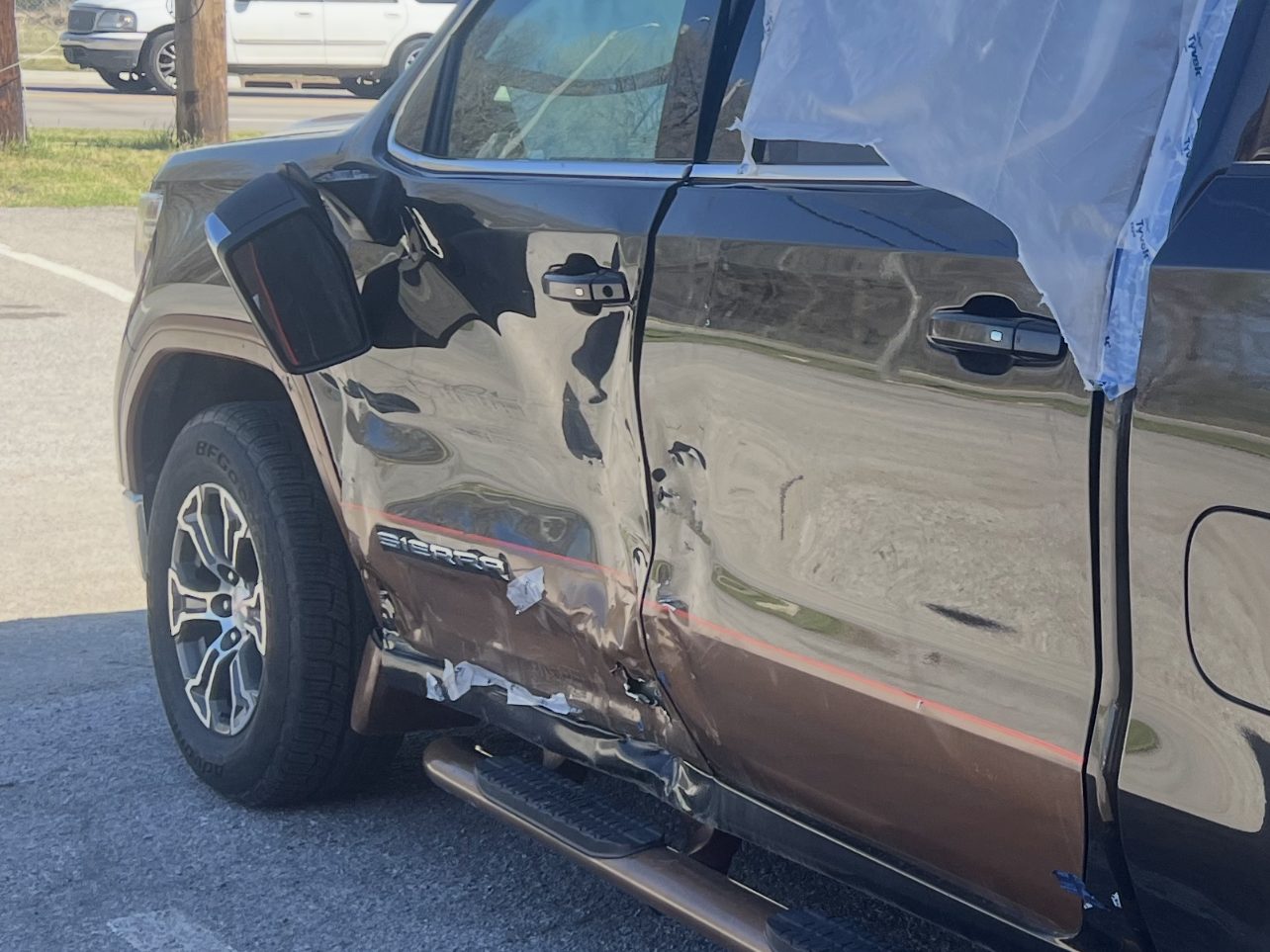 Before: GMC Sierra, driver-side doors, rocker and repaint, at Daviel's in Tulsa